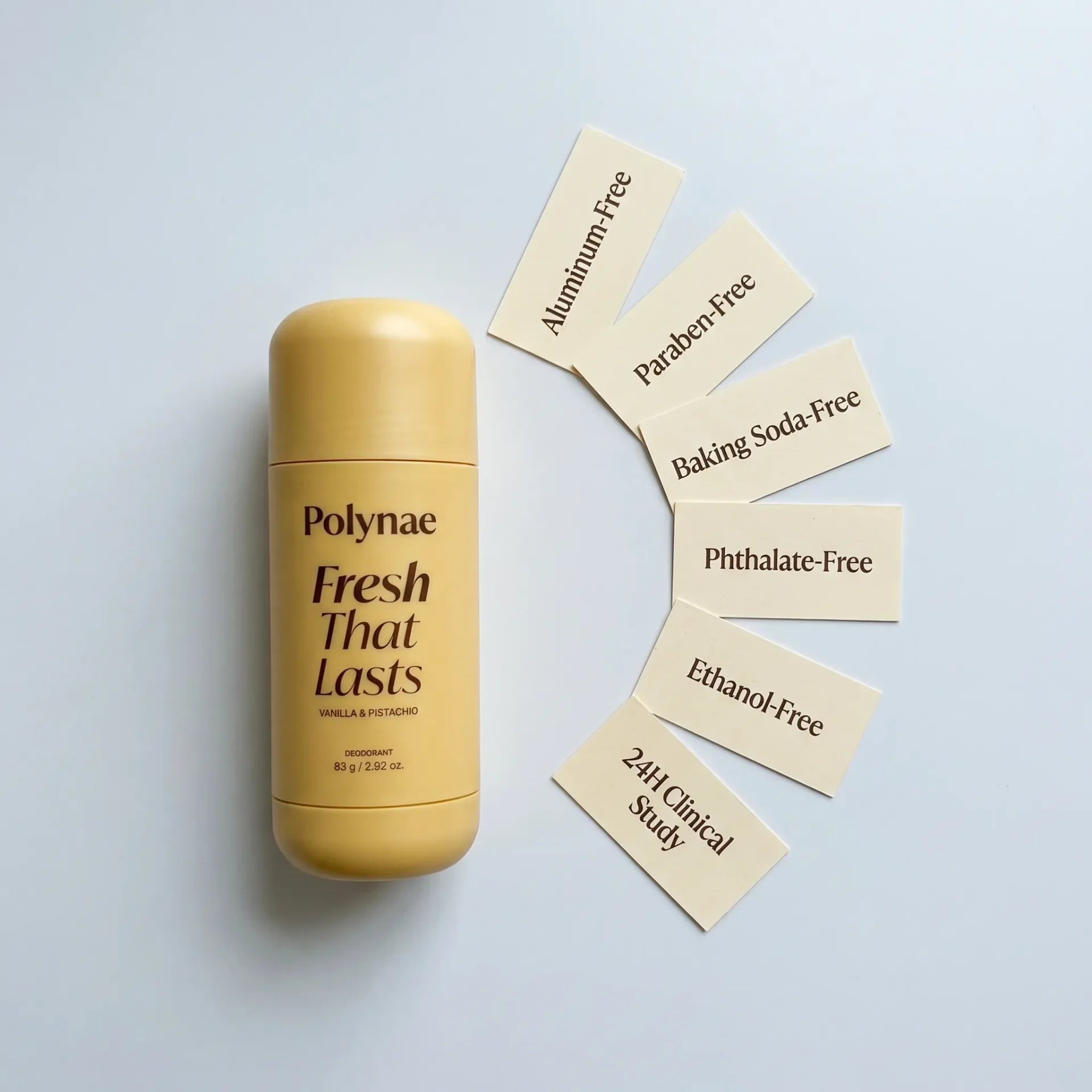 Polynae deodorant stick lying flat next to six cream-colored cards fanned out, each listing a formula credential such as Aluminum-Free and Paraben-Free
