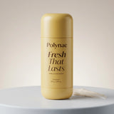 Polynae Fresh That Lasts deodorant stick in matte golden-yellow packaging standing upright on a pale grey surface against a neutral background