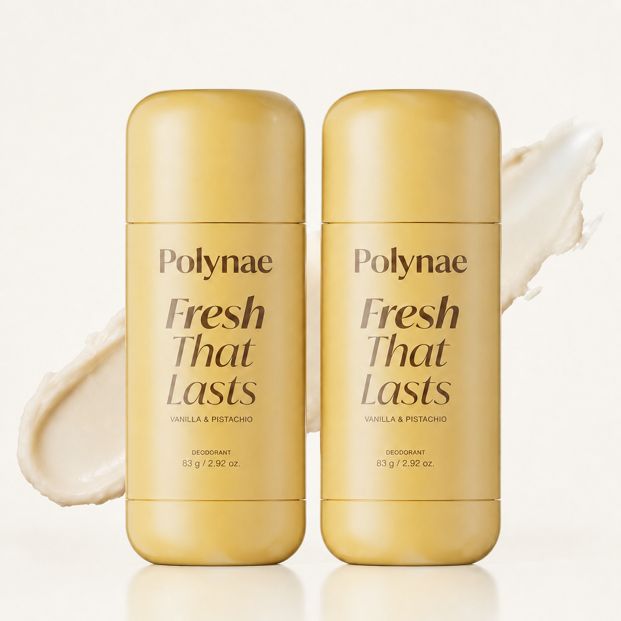 Two Polynae “Fresh That Lasts” Vanilla & Pistachio deodorant sticks in soft golden packaging, standing side by side on a cream background with a subtle product smear behind them.