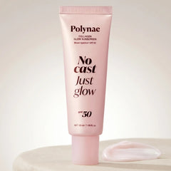 Polynae Collagen Glow Sunscreen tube in pale pink standing upright on a white surface with a cream swatch beside it