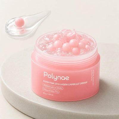 Open jar of Polynae PDRN Pink Collagen Capsule Cream showing pink gel base filled with pink spherical capsule beads, placed on a stone surface beside a glass co