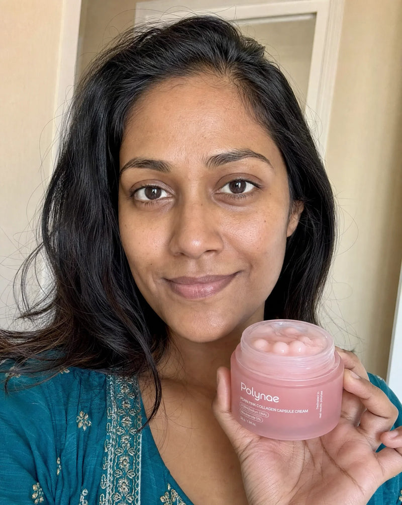 South Asian woman holding Polynae PDRN Pink Collagen Capsule Cream jar, clear glowing skin visible